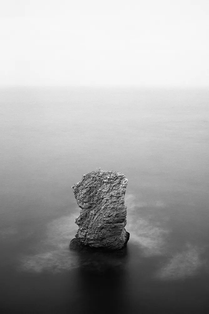 Black and white image of a sea stack